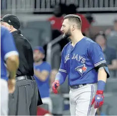  ?? JOHN BAZEMORE/AP ?? Kevin Pillar looks on as both benches empty Wednesday after he directed a homophobic slur at Atlanta Braves relief pitcher Jason Motte. Pillar has been suspended for two games.