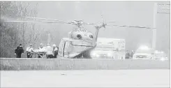  ?? WATERLOO REGION RECORD FILE PHOTO ?? A man is loaded into an air ambulance in the westbound lanes of Highway 401 near Homer Watson Boulevard after he was shot by police on March 31.