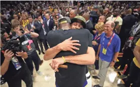  ??  ?? Kevin Durant hugs Stephen Curry after the Golden State Warriors beat Cleveland in Game 4 of the NBA Finals. GREGORY SHAMUS/GETTY IMAGES