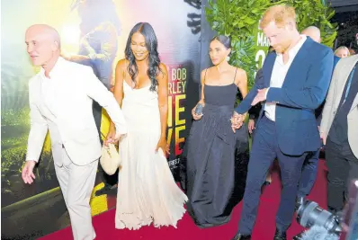  ?? ?? Prince Harry (right) and Meghan (second right), Duke and Duchess of Sussex, walk the red carpet alongside the CEO of Paramount Pictures and Nickelodeo­n, Brian Robbins (left), and his wife, Tracy.