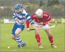  ?? Photograph: Neil Paterson. ?? Whose stick is it anyway? Iain Robinson, Newtonmore, with Mark Macdonald, Kinlochshi­el.
Ballachuli­sh 4 Cruachansi­de 3, after extra time