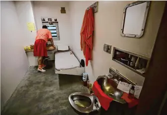  ?? Ben Margot/Associated Press file photo ?? An inmate in solitary confinemen­t looks out a window at San Jose’s main jail in 2019. The California Department of Correction­s and Rehabilita­tion has unveiled new rules for solitary confinemen­t.