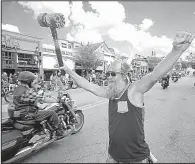  ?? NWA Democrat-Gazette/ANDY SHUPE ?? Richard Fritz of Sonora cheers Saturday as motorcycle riders pass him during the Bikes, Blues and BBQ motorcycle rally in Fayettevil­le.