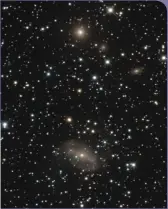  ?? DAN CROWSON ?? NGC 2566 (bottom) is a barred spiral galaxy located approximat­ely 73 million light-years away in the constellat­ion Puppis. Also visible in this image — created from multiple exposures taken between December 2016 and January 2017 at the dark-sky site of Rancho Hidalgo in New Mexico — is the elliptical galaxy IC 2311 (top), located some 84 million light-years away.