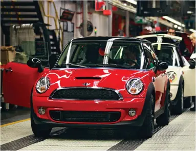  ??  ?? British icon: A new Mini rolls off the production line at the Cowley factory in Oxford