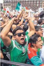  ?? ANTHONY VAZQUEZ/ASSOCIATED PRESS ?? Fans celebrate Mexico’s 1-0 victory against Germany in a World Cup match, as they watched it on an outdoor screen in Mexico City’s Zocalo on Sunday.