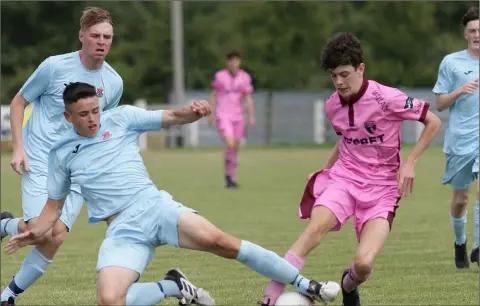  ??  ?? Ciarán Paige of Wexford F.C. is tackled by Adam Crowley (Cobh Ramblers).