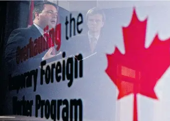  ?? SEAN KILPATRICK/The Canadian Press ?? Employment Minister Jason Kenney, left, and Immigratio­n Minister Chris Alexander are seen in a reflection at a
news conference in Ottawa on Friday announcing reforms to the Temporary Foreign Worker Program.