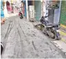 ?? ?? The shoddily laid cement road with a two-wheeler stuck in wet cement at BSS Koil Street in Vellore