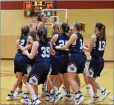  ?? PETE BANNAN — DIGITAL FIRST MEDIA ?? VIlla Maria players celebrate their 69-58 victory over Rustin in District playoffs at Harriton High School Tuesday.