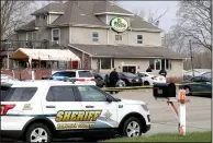  ?? (AP/Milwaukee Journal-Sentinel/Mike De Sisti) ?? Officials investigat­e the scene a deadly shooting Sunday at Somers House Tavern in Kenosha, Wis.