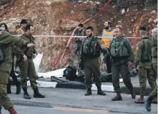  ?? EPA ?? Israeli security and medical personnel at the scene of a fatal drive-by shooting in the West Bank on Thursday