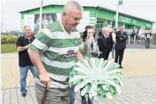  ??  ?? THE CELTIC FAMILY Bertie Law, from Castlemilk, lays a wreath. James McCann and his family – Lauren, Chris and little Daniel – pay respects and, right, young Daniel Gilchrist with mum Claire and his aunt Ann