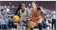  ?? (Arkansas Democrat-Gazette/Justin Cunningham) ?? UALR guard Tia Harvey (left) drives to the basket Thursday in front of Tennessee-Martin guard Paige Pipken at Simmons Bank Arena in North Little Rock. Harvey hit the game-winning three-pointer as time expired to give the Trojans a 45-44 victory. More photos at arkansason­line.com/1230womenu­alr/.