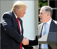  ?? AP/ANDREW HARNIK ?? President Donald Trump yields the lectern to EPA Administra­tor Scott Pruitt after speaking Thursday in the White House Rose Garden about the United States’ role in the Paris climate agreement.