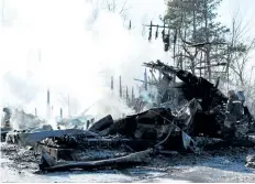  ?? LAURA BARTON/WELLAND TRIBUNE ?? A member of Wainfleet’s fire department walks carefully through the remainders of a home at 11473 Moore Rd. N. in Wainfleet. The home burned down in the early morning hours on Thursday. The wreckage was still smoulderin­g just before noon and was...