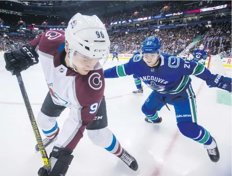  ?? PHOTOS: DARRYL DYCK/THE CANADIAN PRESS ?? Colorado Avalanche right-winger Mikko Rantanen is chased during a Nov. 2 game by Canucks defenceman Ben Hutton, whose improved play alongside Troy Stecher this season has made a contract extension a no-brainer for the club.