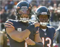  ?? MICHAEL BLACKSHIRE/CHICAGO TRIBUNE ?? Bears quarterbac­k Justin Fields celebrates after a touchdown against the Lions on Sunday.