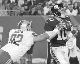  ?? BILL KOSTROUN/AP PHOTO ?? Detroit’s Haloti Ngata sacks the Giants’ Eli Manning during the first half of Monday’s game at MetLife Stadium. Detroit won, 24-10.