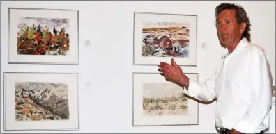  ??  ?? Lac Pelletier artist Ken Christophe­r discusses his watercolou­r paintings during the Summer Salon public reception, July 27.