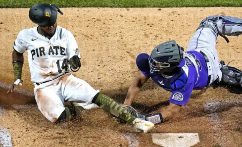  ?? Gene J. Puskar, The Associated Press ?? Pittsburgh Pirates’ Rodolfo Castro is tagged out by Rockies catcher Elias Diaz while attempting to score from third on a fielder’s choice in seventh inning on Monday.