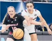  ?? CHARLIE NEIBERGALL/AP ?? South Carolina’s Brea Beal, right, and Louisville’s Hailey Van Lith go after a loose ball in the second half of Friday’s Final Four matchup in Minneapoli­s.