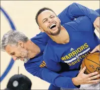  ?? AP PHOTO ?? Golden State Warriors’ Stephen Curry, right, laughs while warming up with assistant coach Bruce Fraser in this June 12, 2017, file photo.