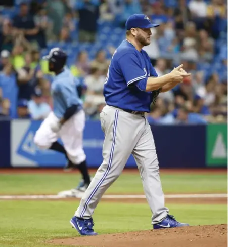  ?? KIM KLEMENT/USA TODAY SPORTS ?? Jays starter Mark Buehrle heads back to the mound after giving up a first-inning grand slam to the Rays’ Joey Butler on Sunday in Florida.