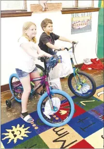  ?? Katie West • Times-Herald ?? Brooklynn Burgess, left and Corbin Graham are this year’s grand finale winners from the Forrest City Public Library’s summer reading program. Children who participat­ed in the program also received goodie bags and books.