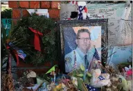  ?? AP/The Orange County Register/DEAN MUSGROVE ?? A photo of Sgt. Ron Helus adorns a memorial in Thousand Oaks, Calif.