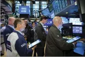  ?? COURTNEY CROW — NEW YORK STOCK EXCHANGE ?? Traders gather at a post on the floor of the New York Stock Exchange on Friday.