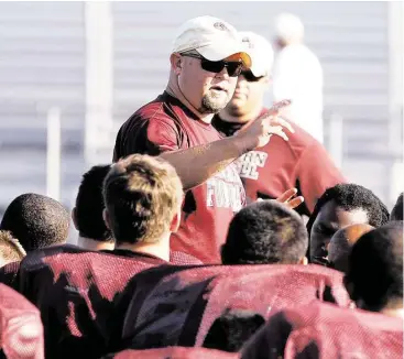  ?? Diana L. Porter / For the Chronicle ?? George Ranch head coach Ricky Tullos and the Class 5A state champion Longhorns are expected to move up to Class 6A when the UIL realigns districts next month.