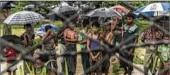  ?? ADAM DEAN/THE NEW YORK ?? Rohingya Muslims behind barbed wire in the Taung Pyo border area where they are stranded between Myanmar and Bangladesh. At least 10 million people globally are stateless, and most — more than 75 percent — are part of minority groups in the countries where they reside.