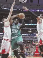  ?? AP PHOTO ?? PATH OF LEAST RESISTANCE: Jae Crowder drives to the hoop between the Bulls’ Nikola Mirotic (left) and Dwyane Wade during the Celtics’ victory in Game 4 in Chicago.