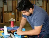  ?? Photos by Spencer Lahr, Rome News-Tribune ?? LEFT: Genderson Hernandez, who is in his second year at GNTC, pulls and strips wires for a timed-skills competitio­n.