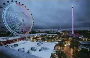  ?? STEPHEN M. DOWELL /ORLANDO SENTINEL VIA AP ?? ICON Park attraction­s, The Wheel, left, Orlando SlingShot, middle, and Orlando FreeFall, right, are shown in Orlando, Fla., on Thursday. A 14-year-old boy fell to his death from a ride at an amusement park in Orlando, sheriff’s officials said. Sheriff’s officials and emergency crews responded to a call late Thursday at Icon Park, which is located in the city’s tourist district along Internatio­nal Drive. The boy fell from the Orlando Free Fall ride, which opened late last year.