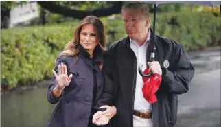  ??  ?? US President Donald Trump and First Lady Melania Trump make their way yesterday to board Marine One from the South Lawn of the White House in Washington, DC.