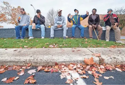  ?? PHOTOS BY ADAM CAIRNS/COLUMBUS DISPATCH ?? A group of regulars at the Downtown Mcdonald’s on Main Street continues to meet in the parking lot every day, rain or shine, even though the dining room is closed. They are, from left, John Kubitschac­k, 66; Robert Long, 78; Pete Wood, 80; Greg Brannon, 65; William Curtis Ellison, 73; and Jack Edwards, 71.