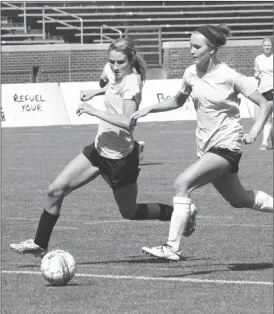  ??  ?? LaFayette High graduate Catherine McConnell (left) looks to outrun Notre Dame graduate Sofia Olenchek to the ball during Friday's Tennessee-Georgia Girls' All-Star Soccer Classic at Finley Stadium. (Messenger photo/Scott Herpst)