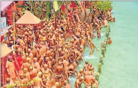  ?? RAMESHWAR GAUR/HT PHOTO ?? Juna Akhada ascetics take holy dip at a Ganga ghat in Haridwar before becoming Naga sanyasis, on Monday.