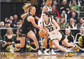  ?? AP PHOTO/HANS PENNINK ?? Colorado guard Kindyll Wetta, left, defends as Iowa’s Caitlin Clark drives during an NCAA tournament Sweet 16 game on Saturday in Albany, N.Y. Iowa won 89-68.