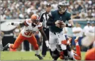  ?? MATT ROURKE — THE ASSOCIATED PRESS ?? Every now and then Sunday the Browns’ defense would put the heat on Eagles quarterbac­k Carson Wentz, like on this play when he’s being pursued by Chris Kirksey and Derrick Kindred.