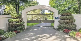  ??  ?? The front gate leads to a winding drive and manicured lawns.