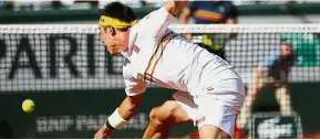  ??  ?? Going all out: Japan’s Kei Nishikori returning a shot against France’s Benoit Paire during their second-round match on Wednesday. — AP