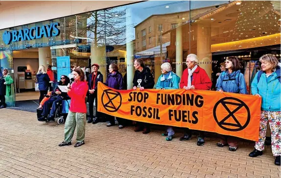  ?? ?? XR protesters at the Broadmead branch of Barclays in Bristol city centre yesterday