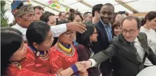  ?? AFP/GETTY IMAGES ?? French President François Hollande greets a group from Ecuador at an exhibit that is part of the climate change conference.