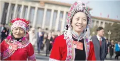  ??  ?? Delegates wearing ethnic minority outfits leave a session of the Chinese People’s Political Consultati­ve Conference in Beijing. — AFP photo