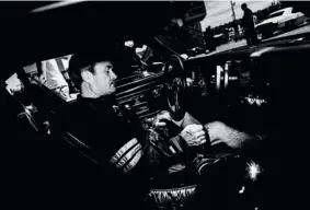  ??  ?? Moment of calm: Raynald Théberge focuses behind the wheel of his 1973 Pontiac Firebird before his next round of racing at Napiervill­e Dragway.