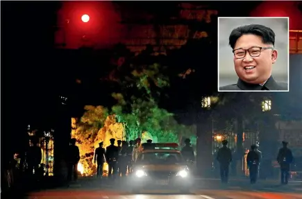  ?? PHOTOS: AP ?? A military honour guard marches away after a convoy of vehicles entered the the Diaoyutai State Guesthouse where top North Korean leaders have been known to stay on previous trips to Beijing. North Korea leader Kim Jong Un is believed to have arrived...
