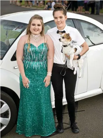  ?? PHOTO: NEV MADSEN ?? BRIGHT FUTURE: Stepping out at the Toowoomba Christian College formal at the Highfields Cultural Centre on Friday are Jess Watkins and Kyrra Lochel, with pooch Keada.